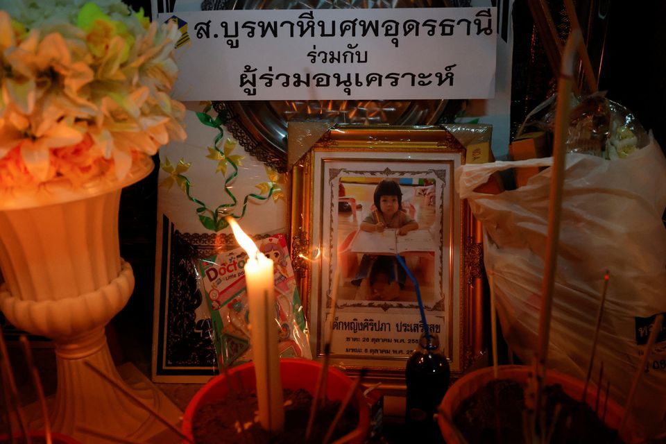 A picture of a child victim is displayed at Wat Rat Samakee temple, which houses coffins of victims for people to pray next to, following a mass shooting in the town of Uthai Sawan, Nong Bua Lam Phu province, Thailand October 7, 2022. Photo: Reuters