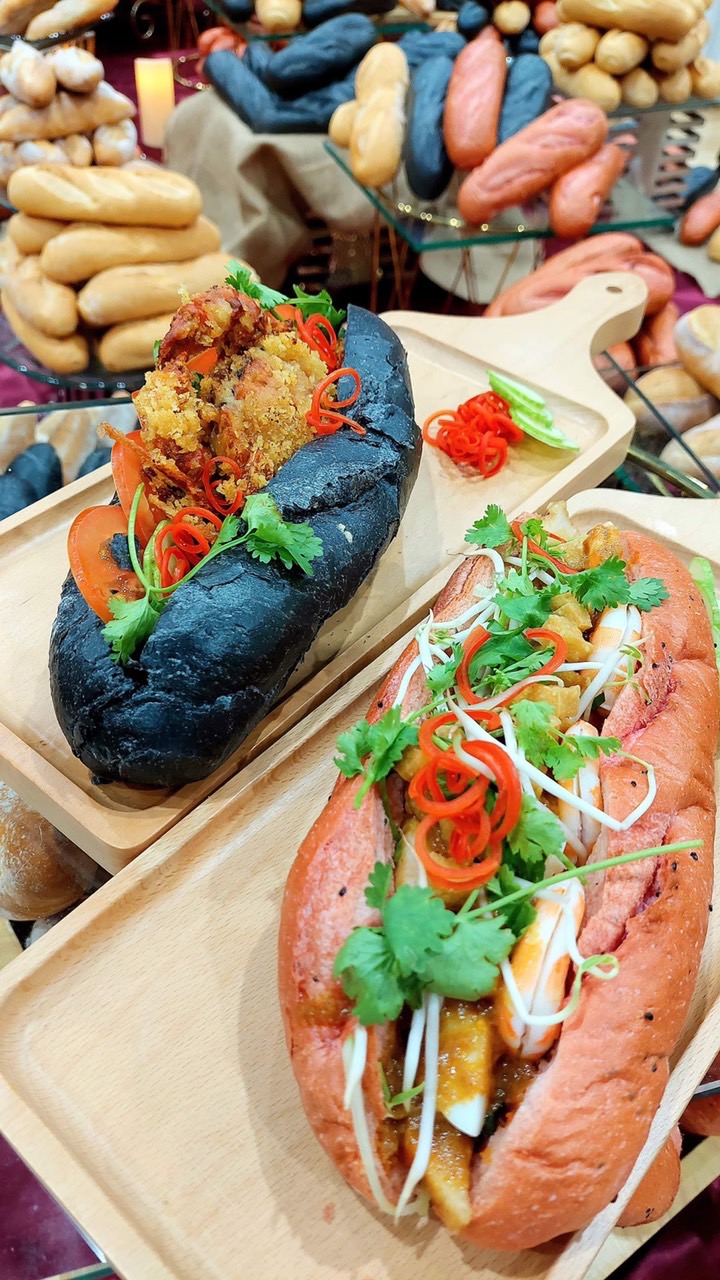 The Laksa and chill crab banh mi are made from bamboo charcoal and dragon fruit breads by Singaporean chef Eric Low. Photo: Supplied