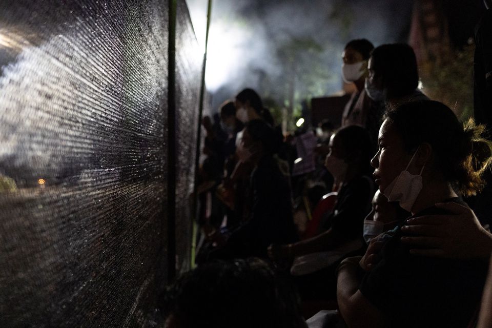 People gather near the funeral pyres of victims, during a cremation ceremony at Wat Rat Samakee temple, following a mass shooting at a day care centre in the town of Uthai Sawan, in the province of Nong Bua Lam Phu, Thailand, October 11, 2022. Photo: Reuters