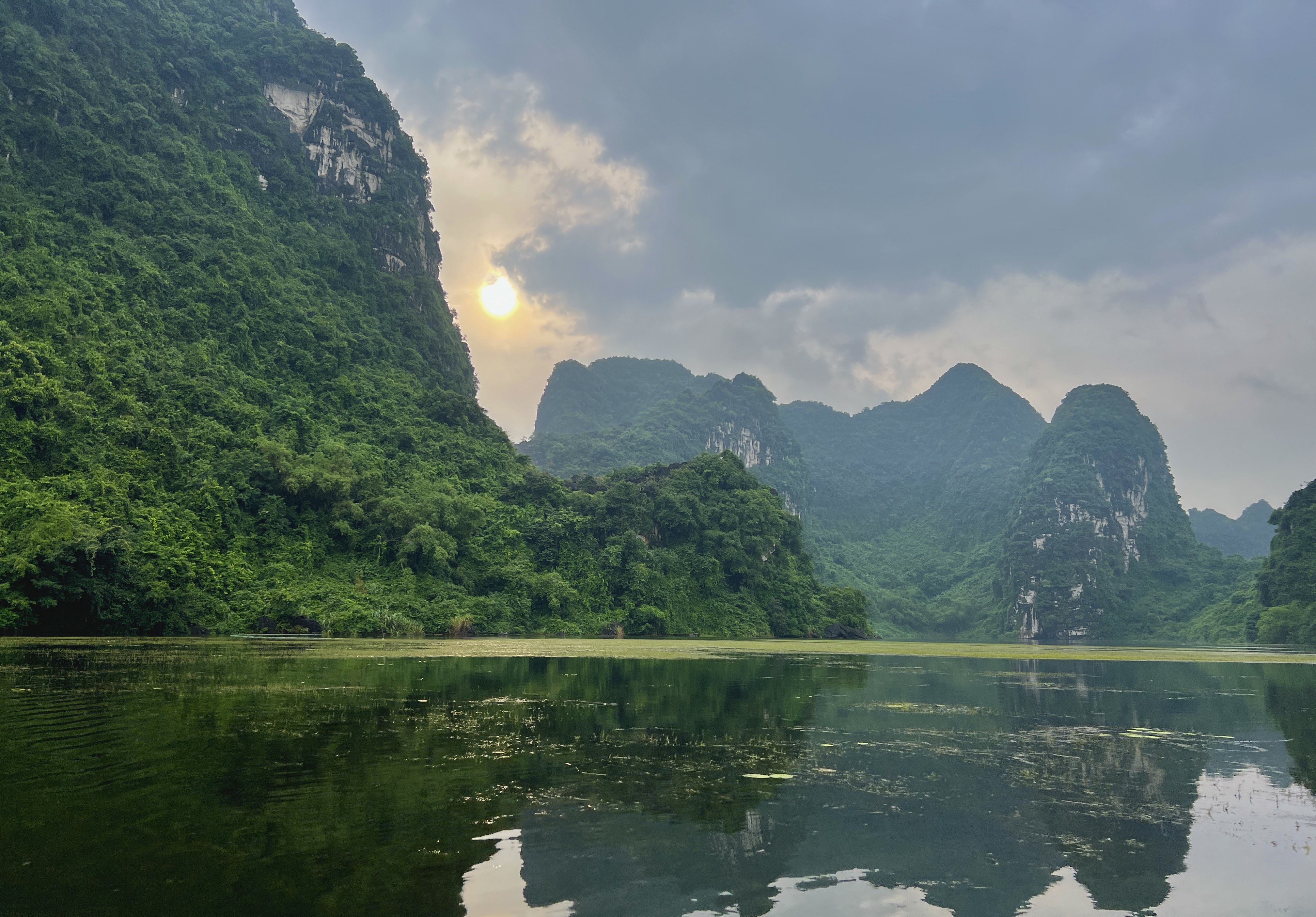 The sun begins to sink below the horizon at Trang An Scenic Landscape Complex, Ninh Binh Province, northern Vietnam. Photo: Linh To / Tuoi Tre News