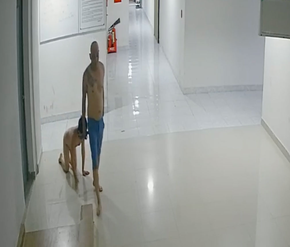 Nguyen Thanh Luan keeps his son on a leash and forces him to crawl along the hallway in Da Lat City, Lam Dong Province, Vietnam, October 19, 2022 in this screenshot taken from the CCTV footage.