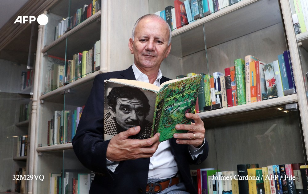 Colombian collector Jorge Salazar holds an English edition of 'One Hundred Years of Solitude', by Colombian Nobel Prize in Literature Gabriel Garcia Marquez, during an interview with AFP at his house in Armenia, Quindio department, Colombia, on October 23, 2022. Photo: AFP