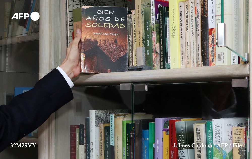 Colombian collector Jorge Salazar holds a Spanish edition of 'One Hundred Years of Solitude', by Colombian Nobel Prize in Literature Gabriel Garcia Marquez, during an interview with AFP at his house in Armenia, Quindio department, Colombia, on October 23, 2022. Photo: AFP