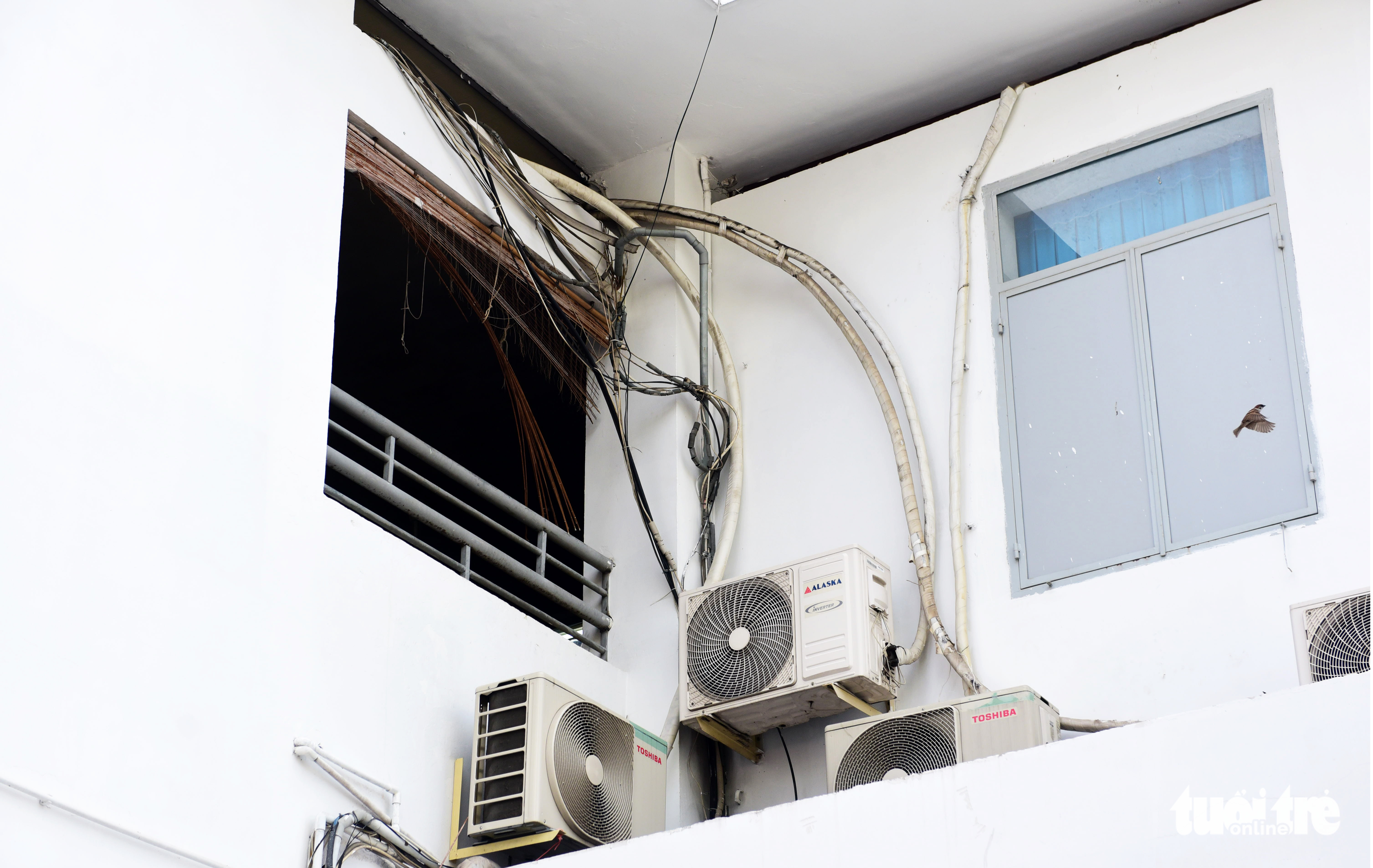 Tangled electric wires are seen outside a room at the Ho Chi Minh City Hospital for Tropical Diseases. Photo: Duyen Phan / Tuoi Tre