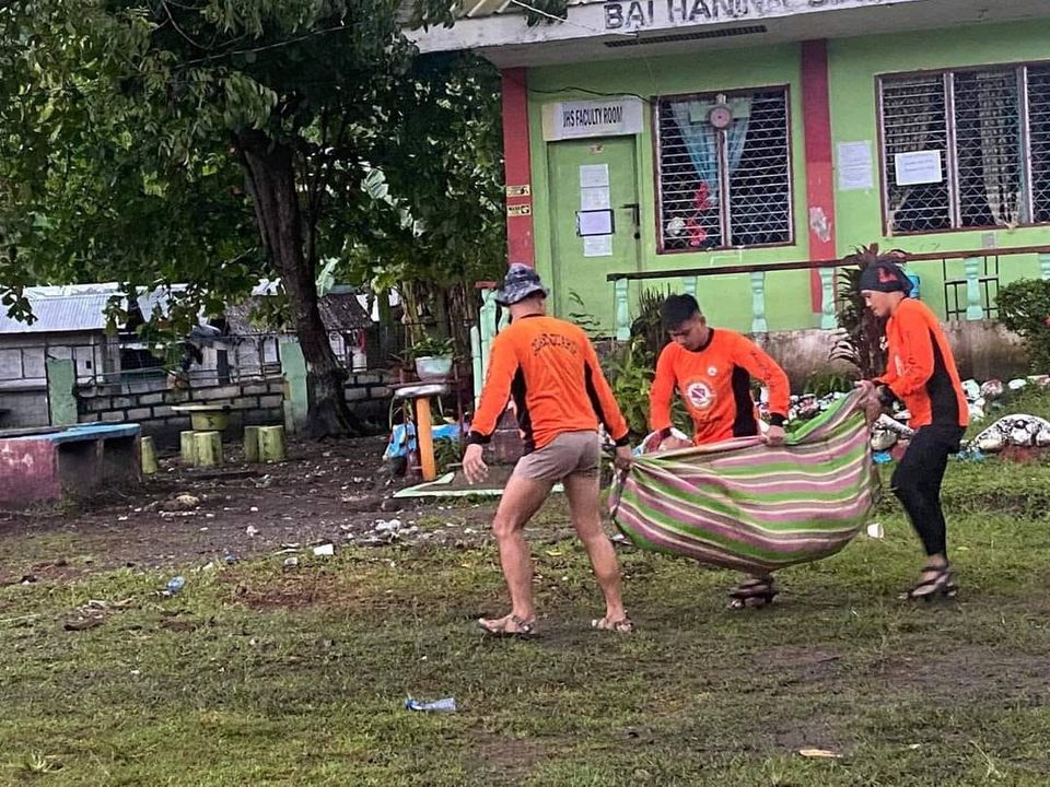 Philippine Coast Guard (PCG) rescuers carry a retrieved body following flooding and landslides due to Tropical Storm Nalgae, in Datu Odin Sinsuat, Maguindanao, October 28, 2022. Philippine Coast Guard/Handout via Reuters