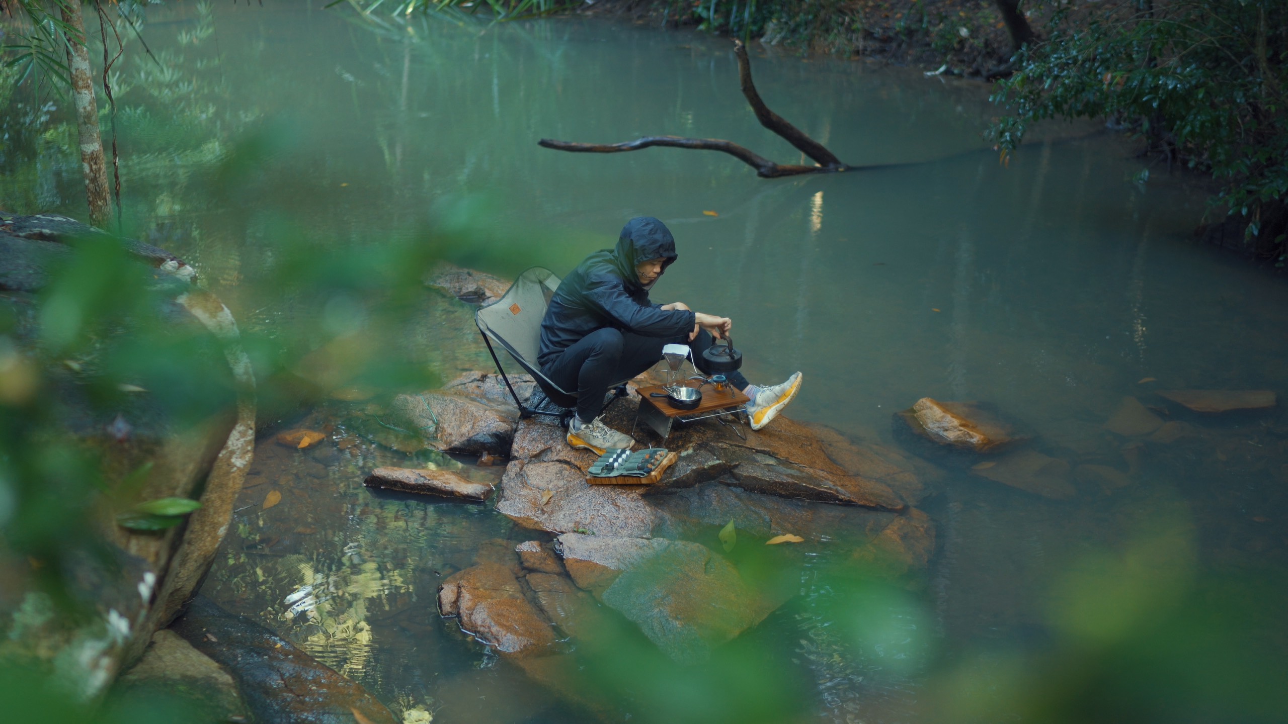 A supplied photo shows Lu Hoang Thong cooking his food by a spring during a solo trip.