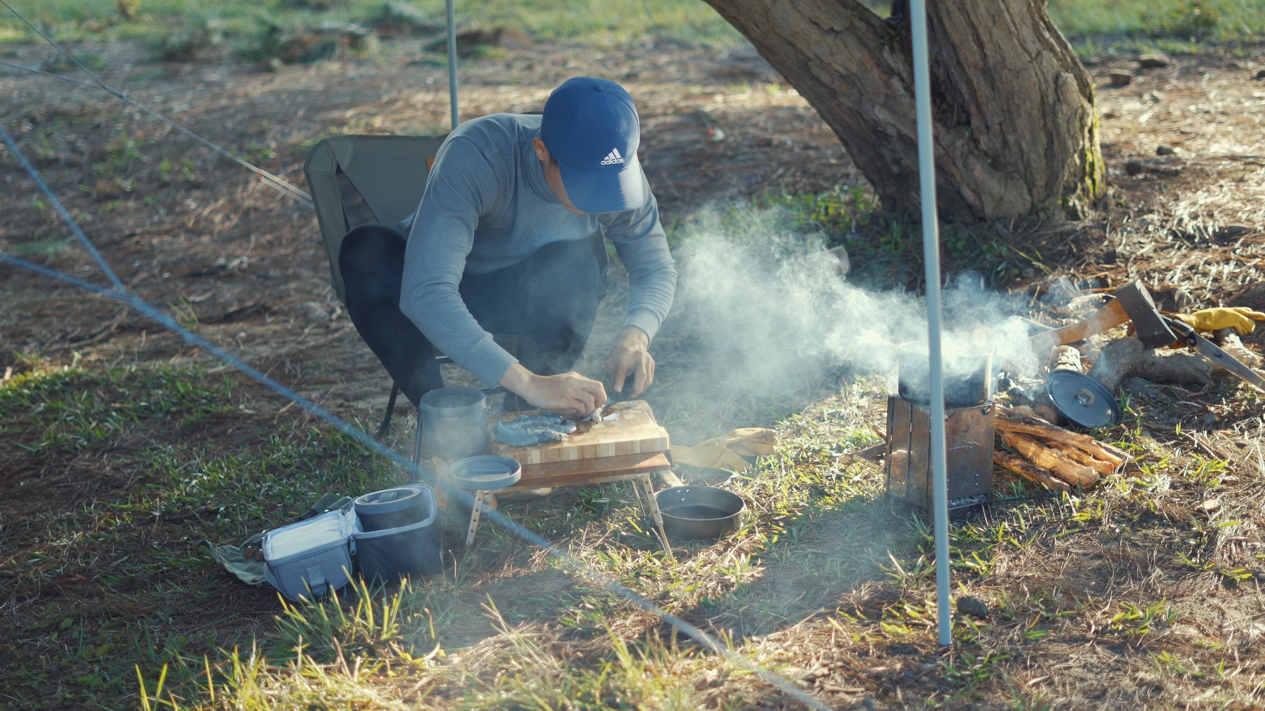 A supplied photo shows Lu Hoang Thong cooking his food in the forest during a solo camping trip.