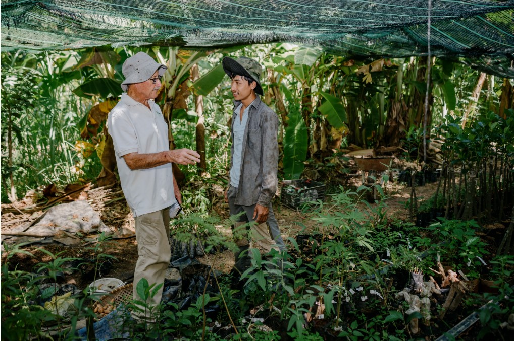 Nguyen Van Nhan (right) is content with life on his farm in central Quang Nam Province (photo).