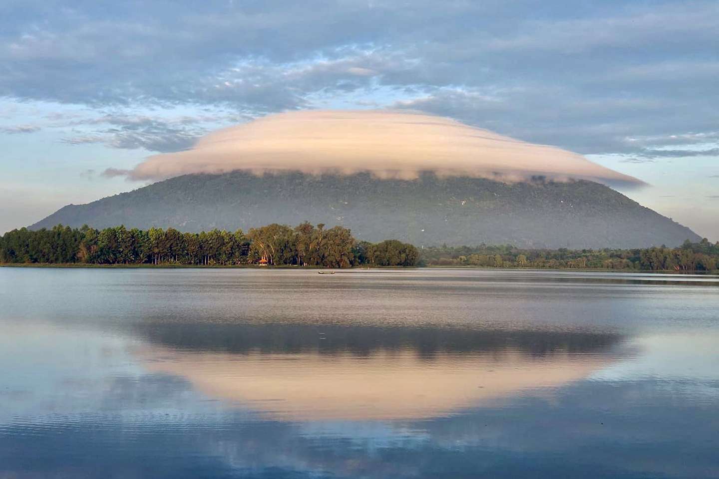Flying saucer-shaped clouds float above another mountain in southern Vietnam
