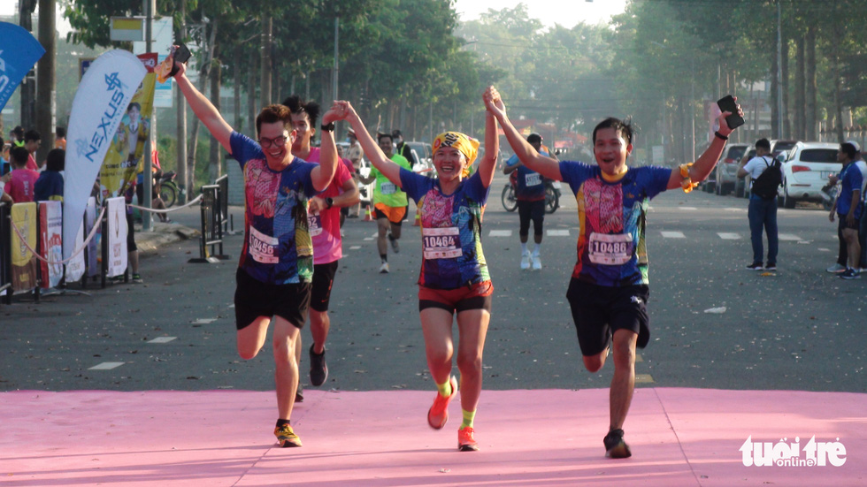 A group of runners reach the finish line.