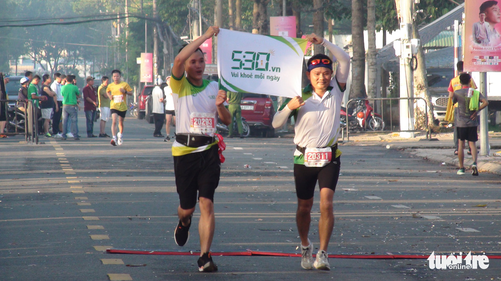 Two male runners with the message ‘Happy and healthy every day.’