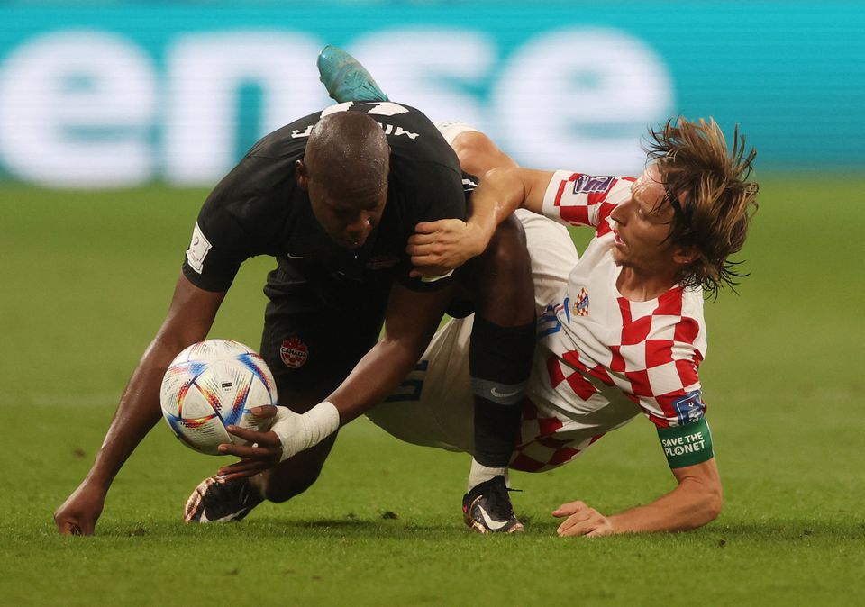 Soccer Football - FIFA World Cup Qatar 2022 - Group F - Croatia v Canada - Khalifa International Stadium, Doha, Qatar - November 27, 2022 Croatia's Luka Modric in action with Canada's Kamal Miller. Photo: Reuters