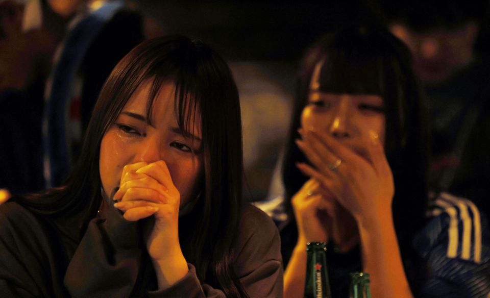 Soccer Football - FIFA World Cup Qatar 2022 - Fans in Tokyo watch Japan v Croatia - Tokyo, Japan - December 6, 2022 Japan fans look dejected at the Bee bar after the penalty shootout as Japan are eliminated from the World Cup. Photo: Reuters