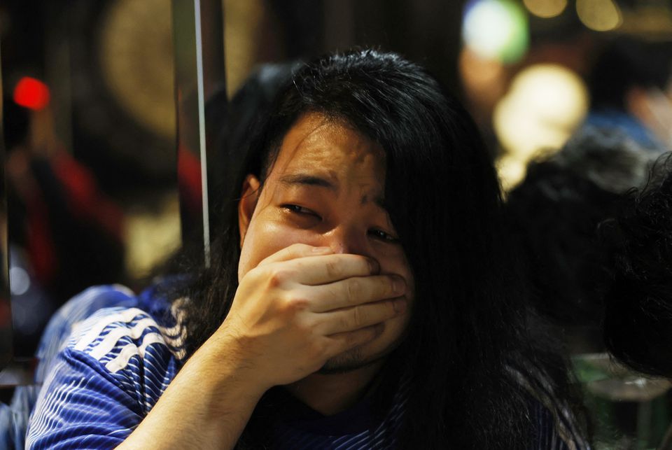 Soccer Football - FIFA World Cup Qatar 2022 - Fans in Tokyo watch Japan v Croatia - Tokyo, Japan - December 6, 2022 A Japan fan looks dejected at the Bee bar after the penalty shootout as Japan are eliminated from the World Cup. Photo: Reuters