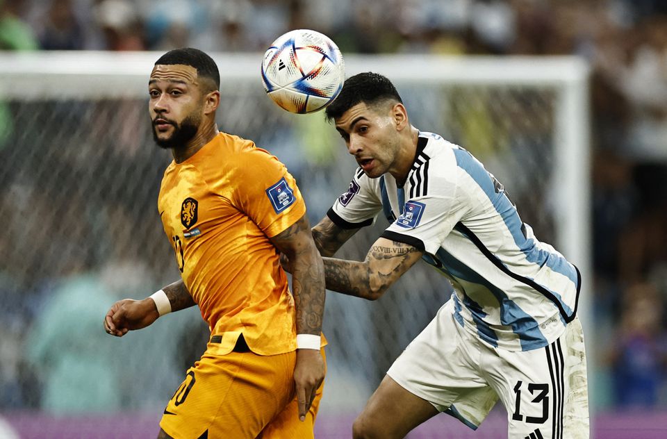 Soccer Football - FIFA World Cup Qatar 2022 - Quarter Final - Netherlands v Argentina - Lusail Stadium, Lusail, Qatar - December 9, 2022 Netherlands' Memphis Depay in action with Argentina's Cristian Romero REUTERS/Hamad I Mohammed