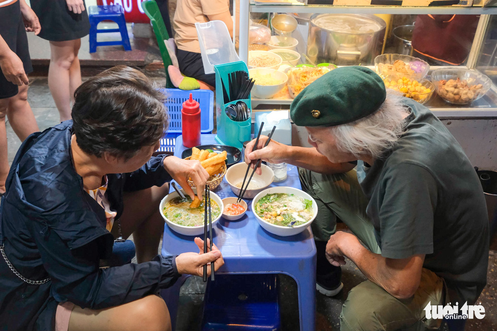 Customers enjoy ‘bun thang’ at 48 Cau Go Street, Hoan Kiem District, Hanoi. Photo: Nam Tran / Tuoi Tre