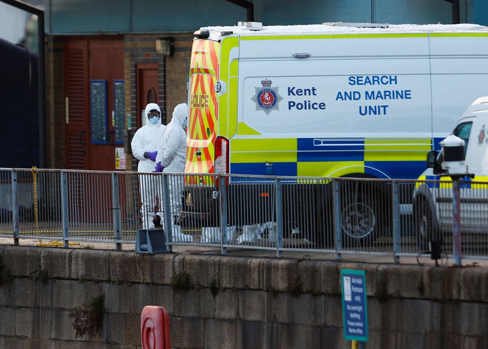 Police forensics officers wearing protective gear gather next to a Search and Marine Unit vehicle, amid a rescue operation of a missing migrant boat, at the Port of Dover in Dover, Britain December 14, 2022. Photo: Reuters