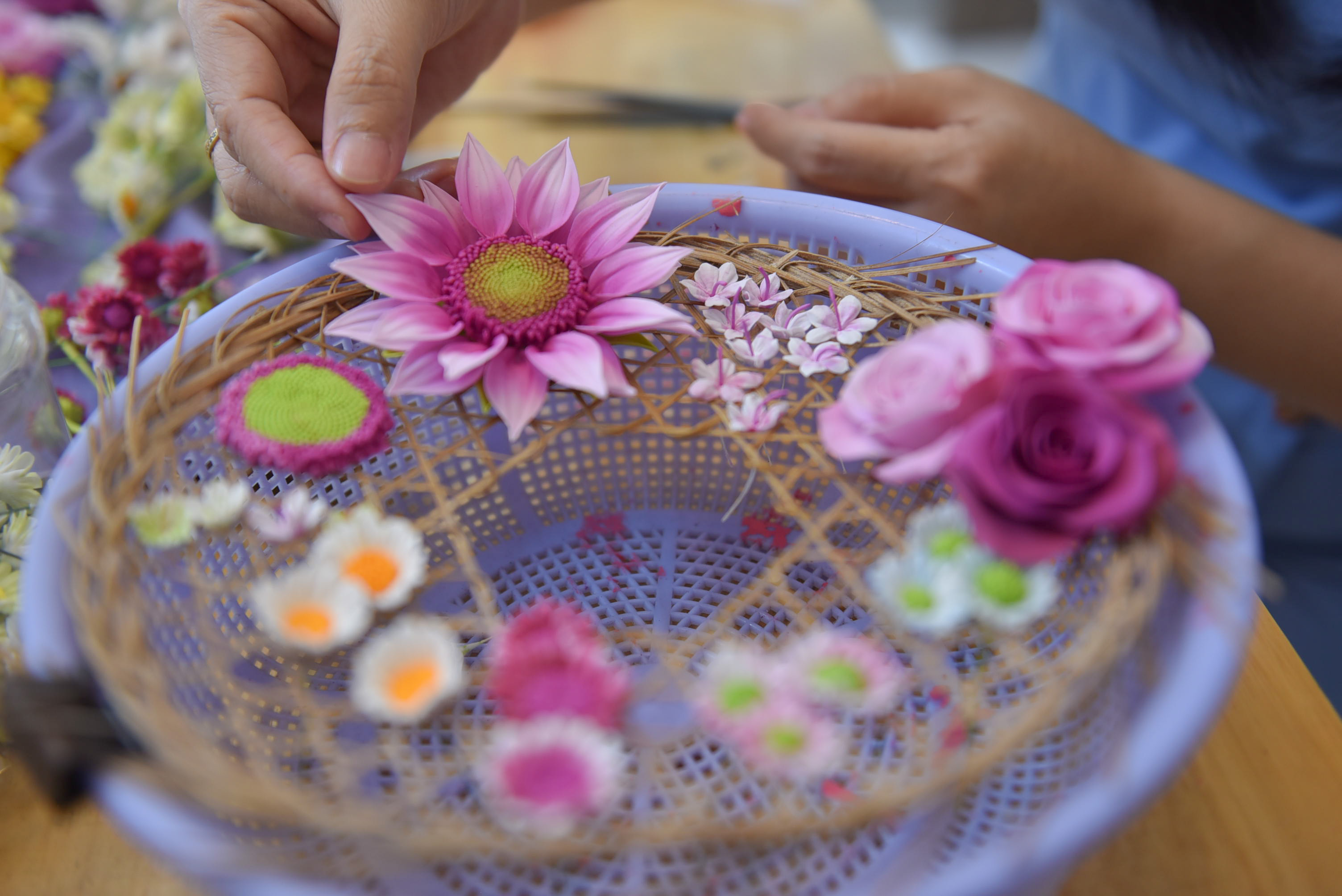 The flowers Giang Sinh uses are made from clay and then colored and glued onto the painting. Photo: Ngoc Phuong / Tuoi Tre News