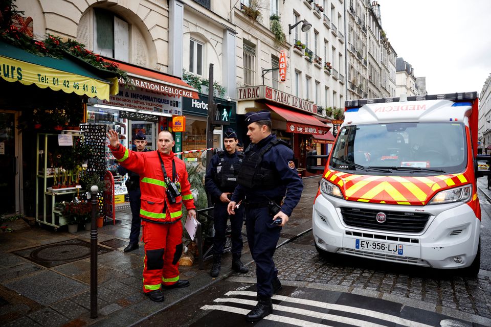 French police and firefighters secure a street after gunshots were fired killing two people and injuring several in a central district of Paris, France, December 23, 2022. REUTERS/Sarah Meyssonnier