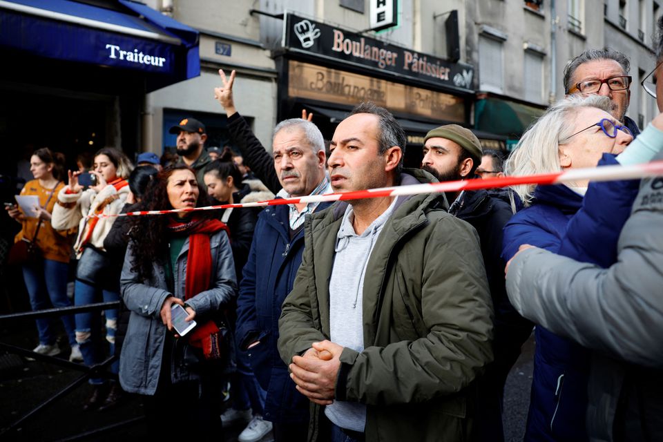 People gather near the Rue d'Enghien after gunshots were fired killing and injuring several people in a central district of Paris, France, December 23, 2022. REUTERS/Sarah Meyssonnier