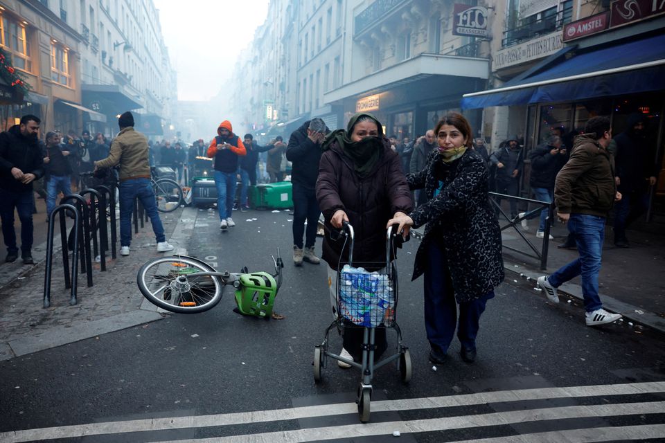 Protestors clash with French police during a demonstration near the Rue d'Enghien after gunshots were fired killing and injuring several people in a central district of Paris, France, December 23, 2022. REUTERS/Sarah Meyssonnier