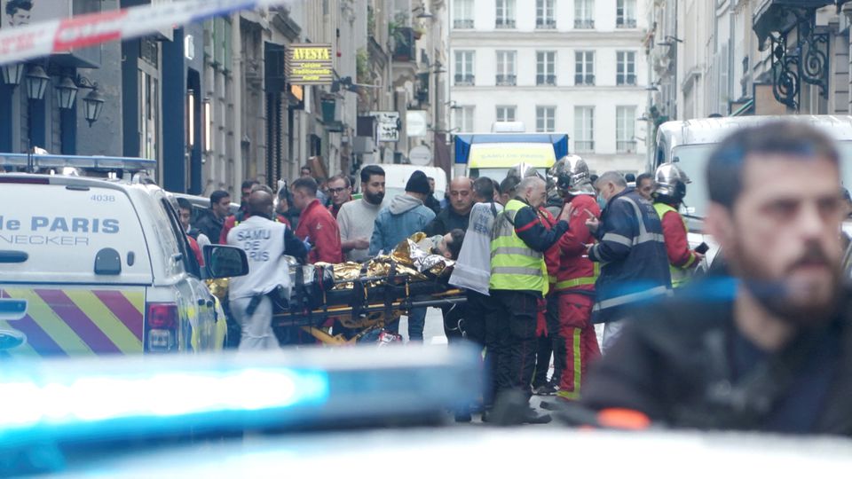 First responders move a man on a gurney after gunshots were fired in central Paris, France, December 23, 2022, in this still image obtained form a social media video. Clement Lanot/via REUTERS