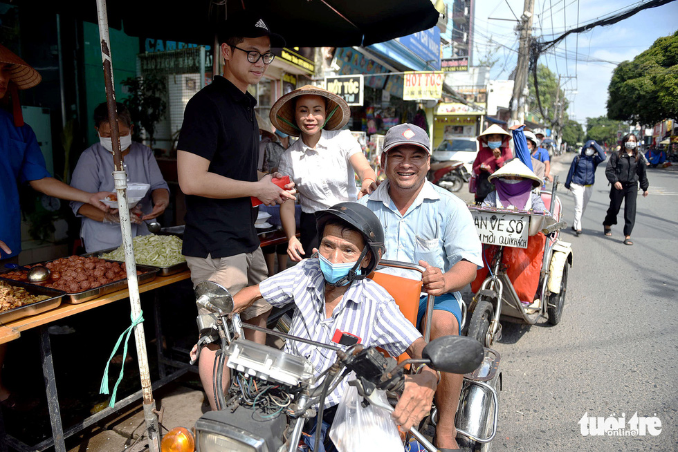Nguyen Van Dai (sitting at the back of the motorized tricycle) and his four family members often visit Huy and Nga for free meals.
