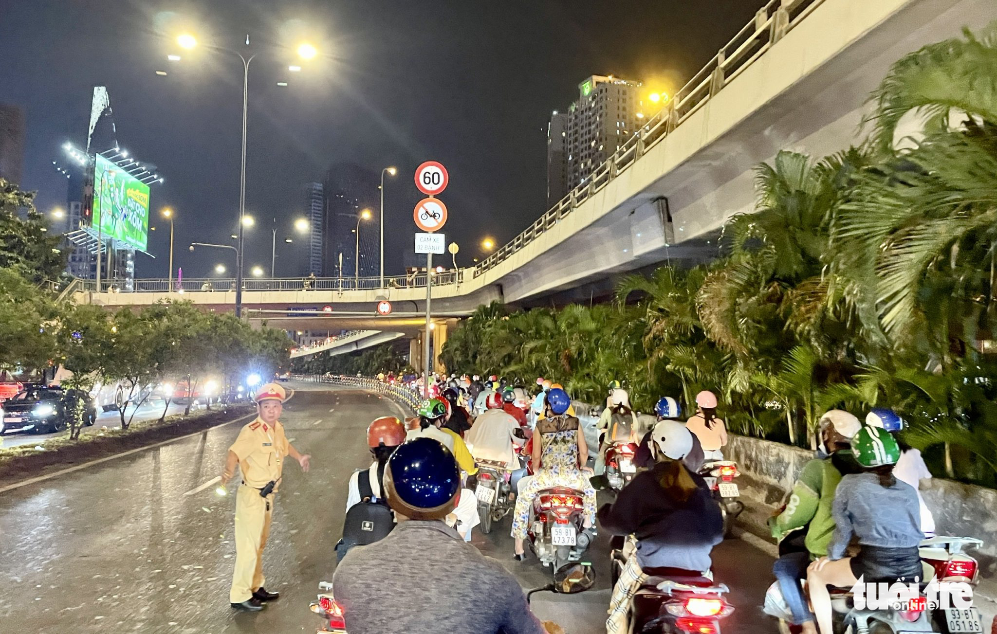 A traffic police officer regulates traffic on Vo Van Kiet Boulevard following a pile-up in the Saigon River Tunnel in Ho Chi Minh City, December 30, 2022. Photo: Chau Tuan / Tuoi Tre