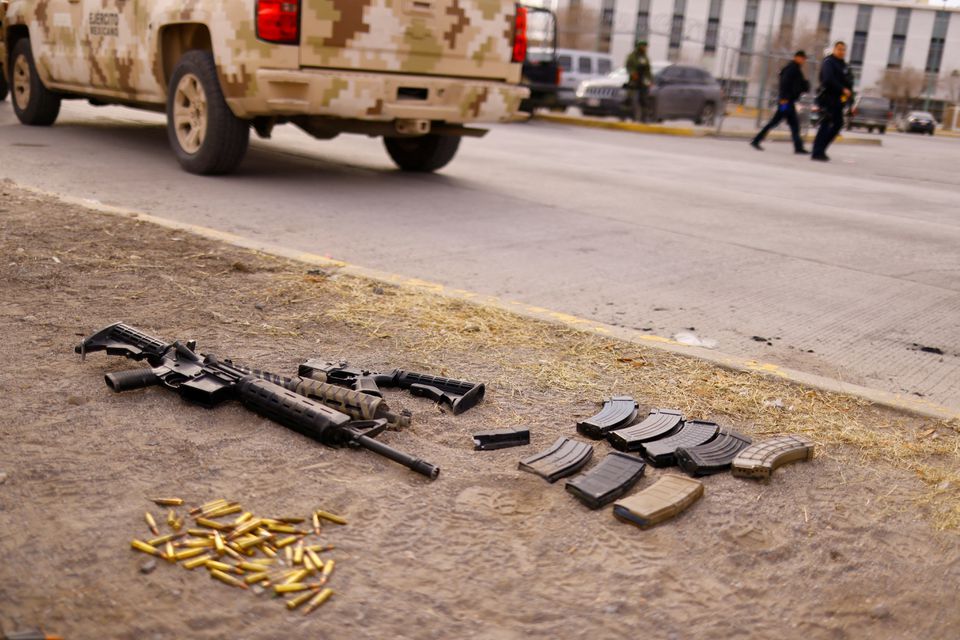 Guns and bullets are seen in front of the Cereso state prison number 3 secured by the security Forces after unknown assailants entered the prison and freed several inmates, resulting in injuries and deaths, according to local media, in Ciudad Juarez, Mexico January 1, 2023. REUTERS /Jose Luis Gonzalez