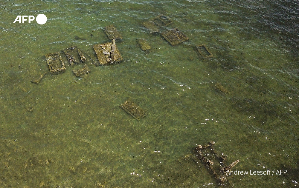 This picture taken on December 13, 2022 shows an aerial view of submerged tombs in a village graveyard, now underwater due to the effects of climate change, in the coastal town of Togoru, some 35 kilometres from Fijis capital city Suva. Photo: AFP