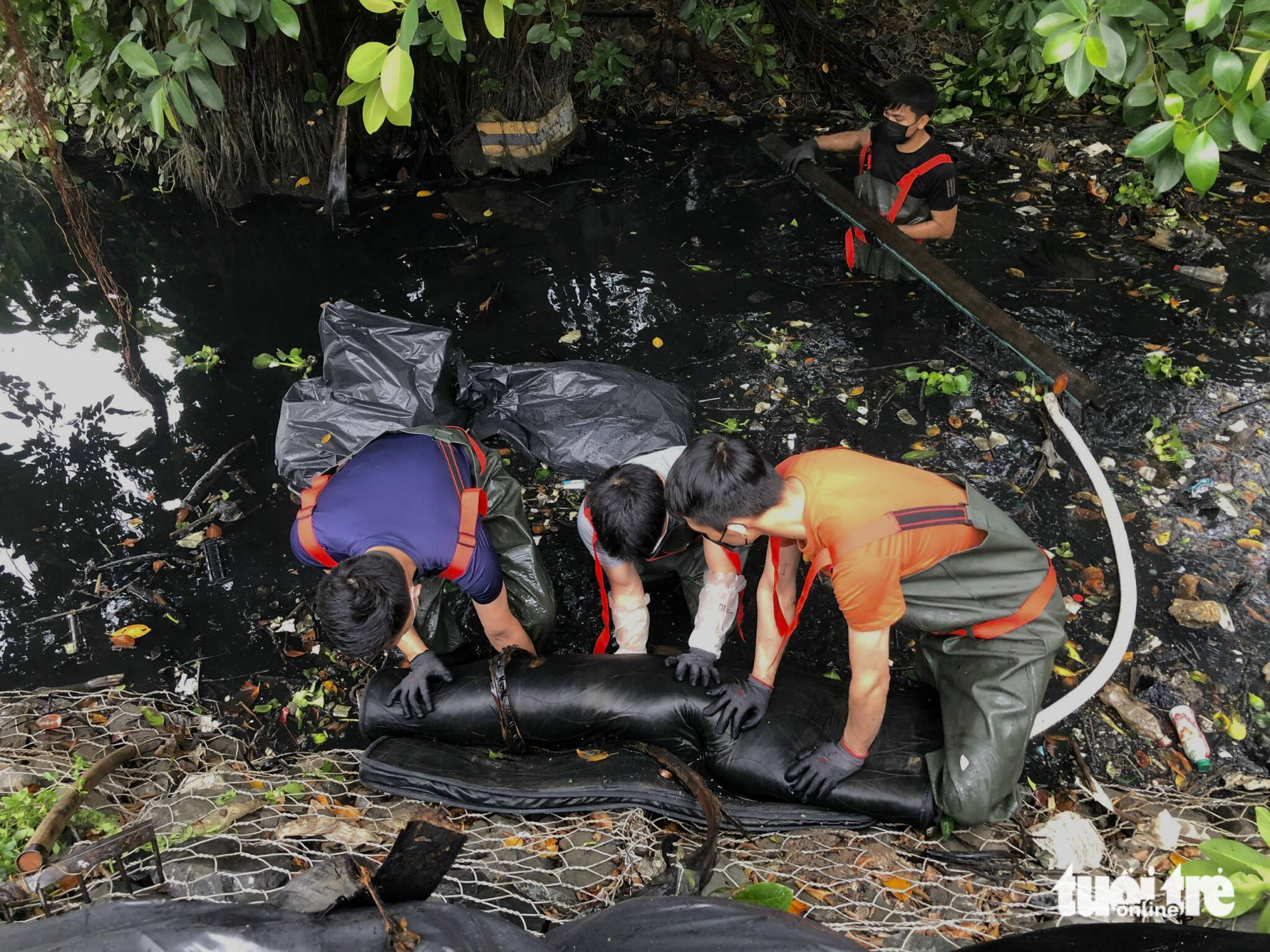 They pull a 60-kilogram mattress soaked in water and mud from the bottom of a river.