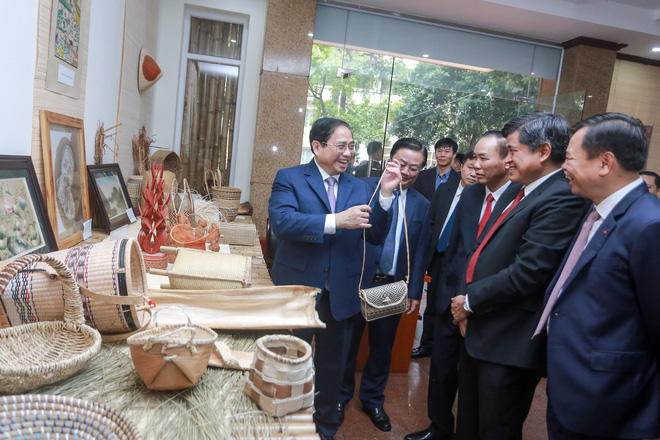 Prime Minister Pham Minh Chinh holds a handbag at an area displaying products made from bamboo and rattan on the sidelines of the conference on January 13, 2022 in this image Photo: Chi Tue / Tuoi Tre