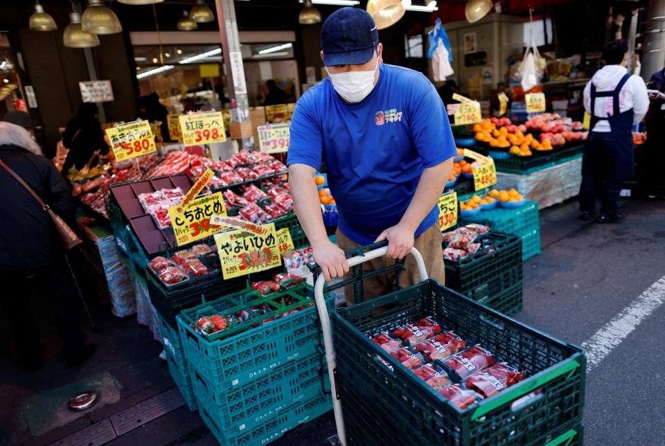 An employee of a supermarket named Akidai works at a store in Tokyo, Japan January 20, 2023. Photo: Reuters