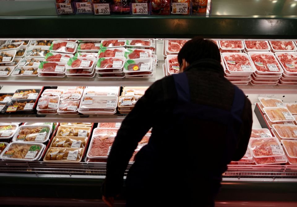 An employee of a supermarket named Akidai works at a meat corner inside a store in Tokyo, Japan January 20, 2023. Photo: Reuters