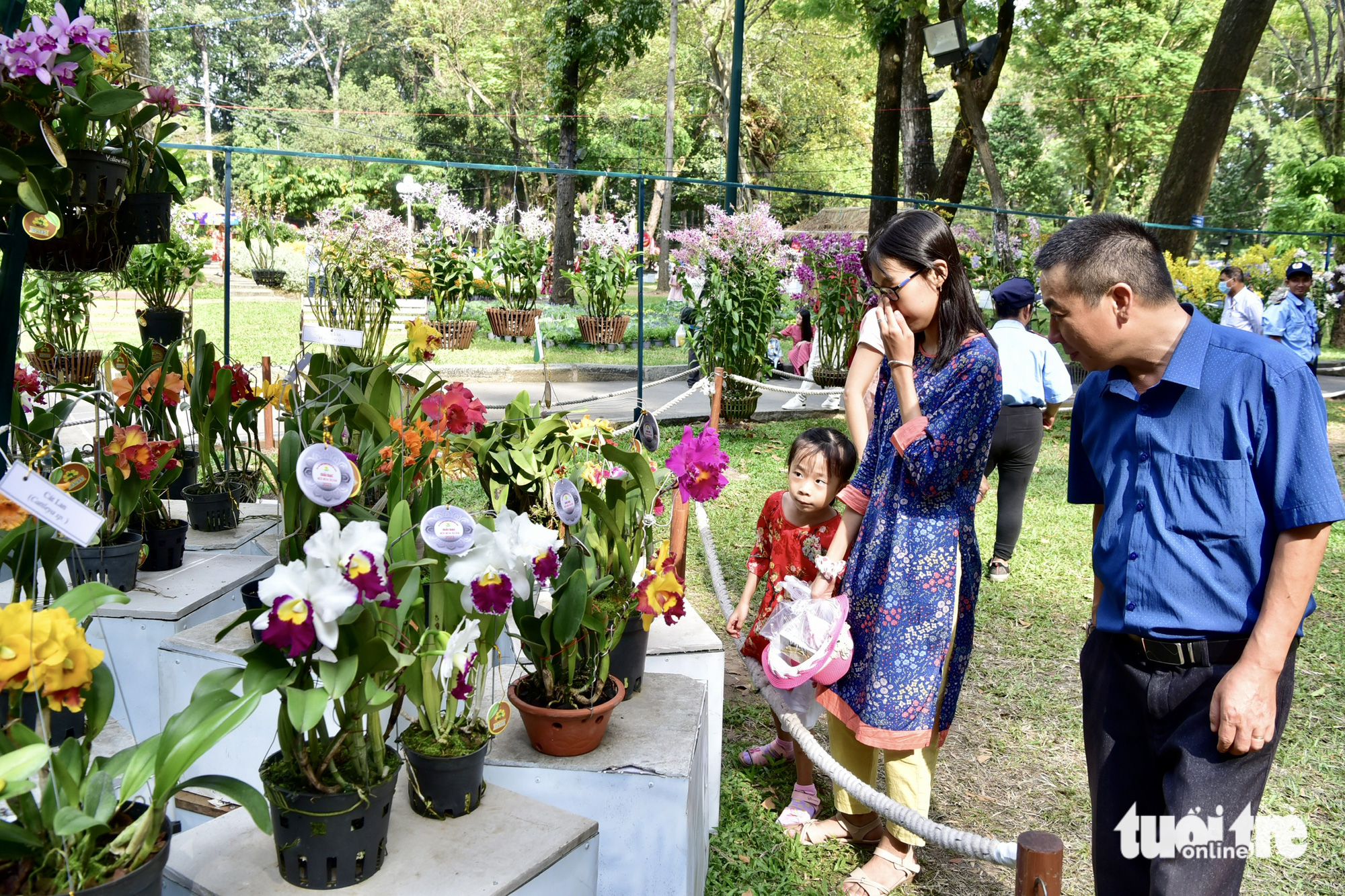 A family is seen looking at orchids at a spring flower area in Ho Chi Minh City on  January 22, 2023.  Photo: T.T.D. / Tuoi Tre