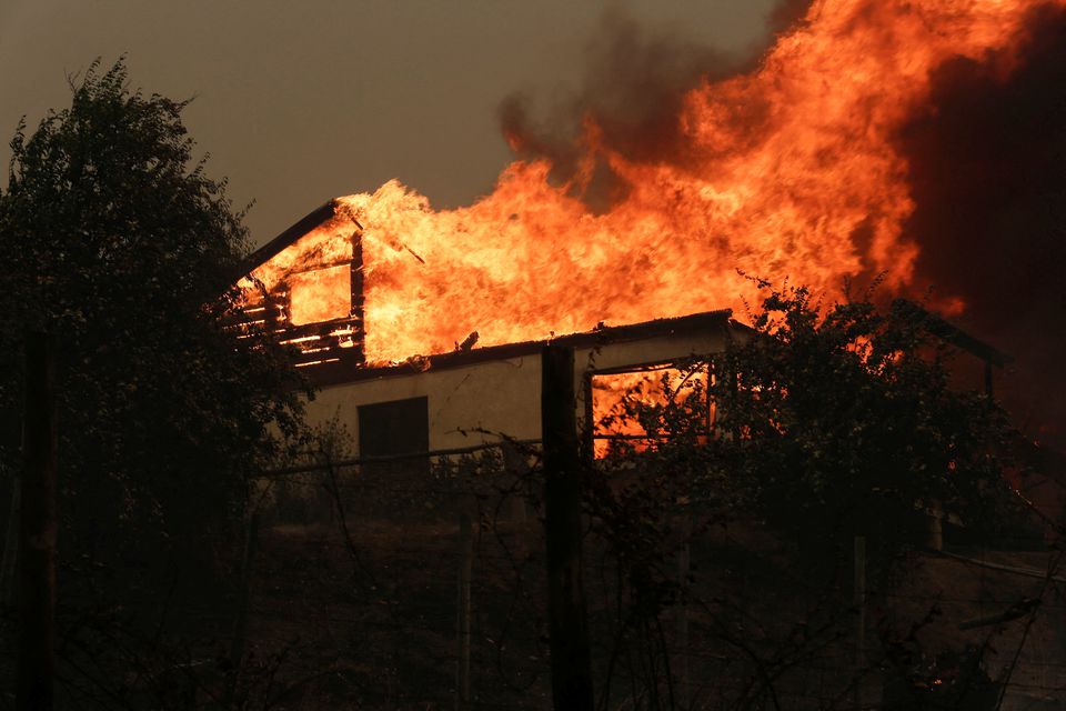 A residence is seen on fire in Santa Juana, near Concepcion, Chile, February 3, 2023. Photo: Reuters