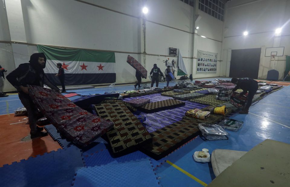 Volunteers prepare mattresses at a temporary shelter inside a sports center, in the aftermath of the earthquake, in rebel-held town of Azaz, Syria February 6, 2023. Photo: Reuters