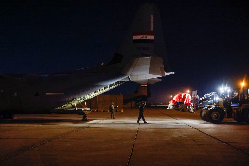 Workers and security forces process aid from Red Crescent that will be shipped on a plane of emergency relief to Syria to support victims of the deadly earthquake, at a military airbase near Baghdad International Airport, in Baghdad, Iraq, February 6, 2023. Photo: Reuters