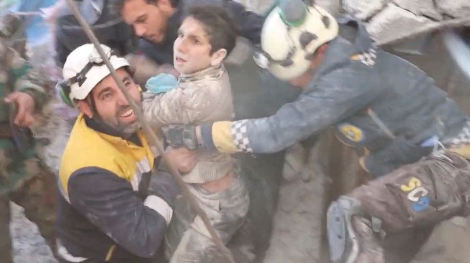 The White Helmet volunteers rescue a child from under rubble, in the aftermath of a deadly earthquake, in Jandaris, Syria February 8, 2023, in this still image obtained from a social media video. Photo: The White Helmets/via Reuters