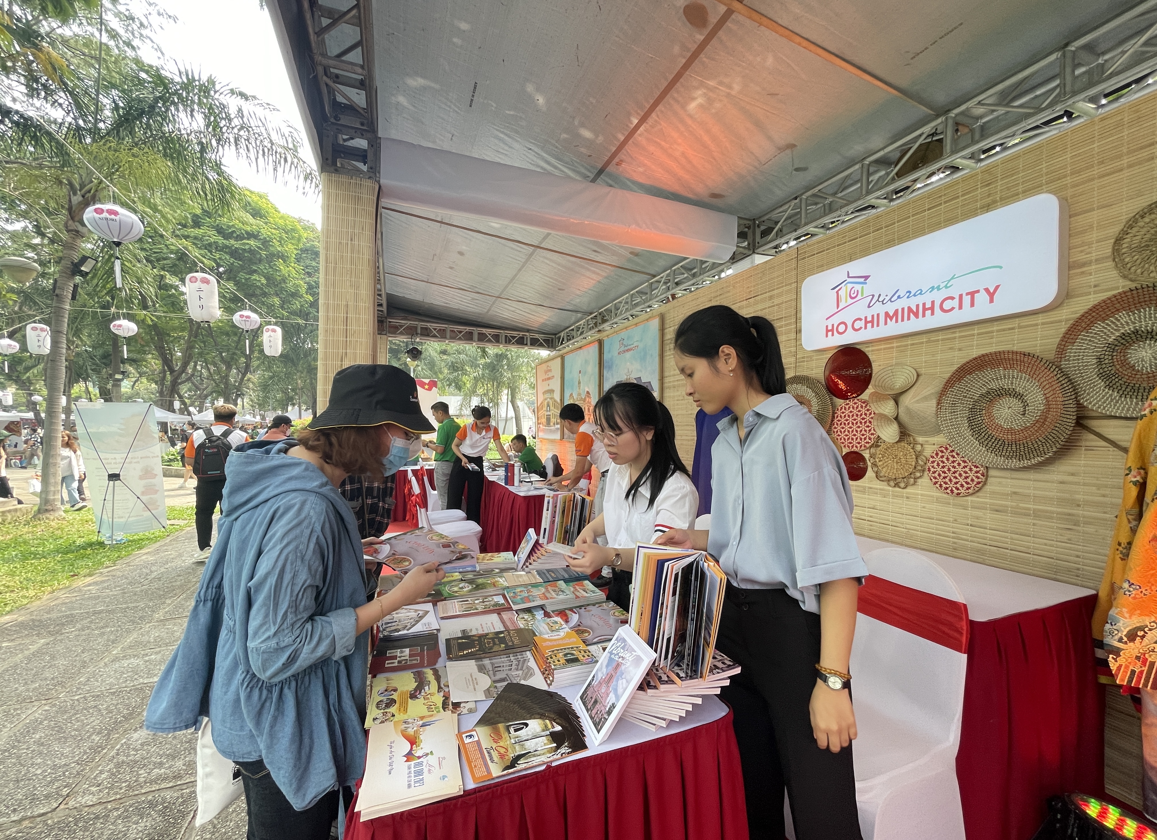 A visitor looks for information about Ho Chi Minh City tourism’s products at a booth at the Japan Vietnam Festival in Ho Chi Minh City on February 25, 2023. Photo: Dong Nguyen / Tuoi Tre News