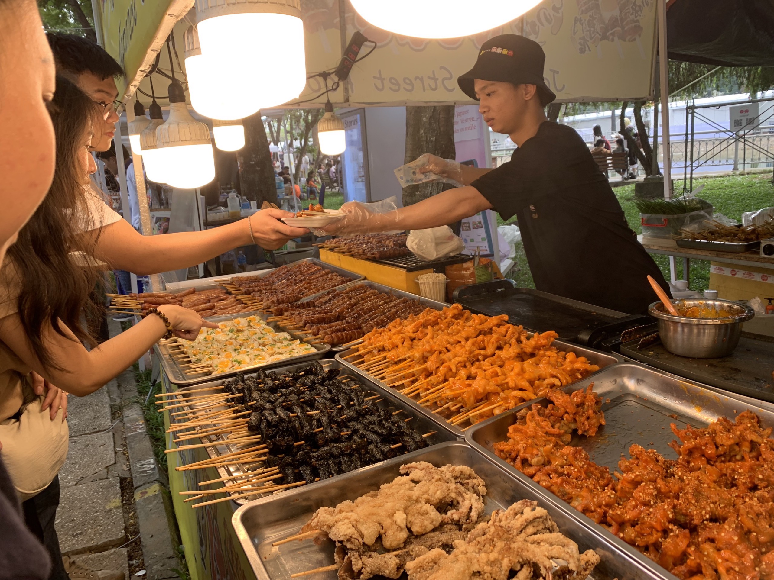 Visitors buy grilled food at a booth at the Japan Vietnam Festival in Ho Chi Minh City on February 25, 2023. Photo: Bao Anh / Tuoi Tre News