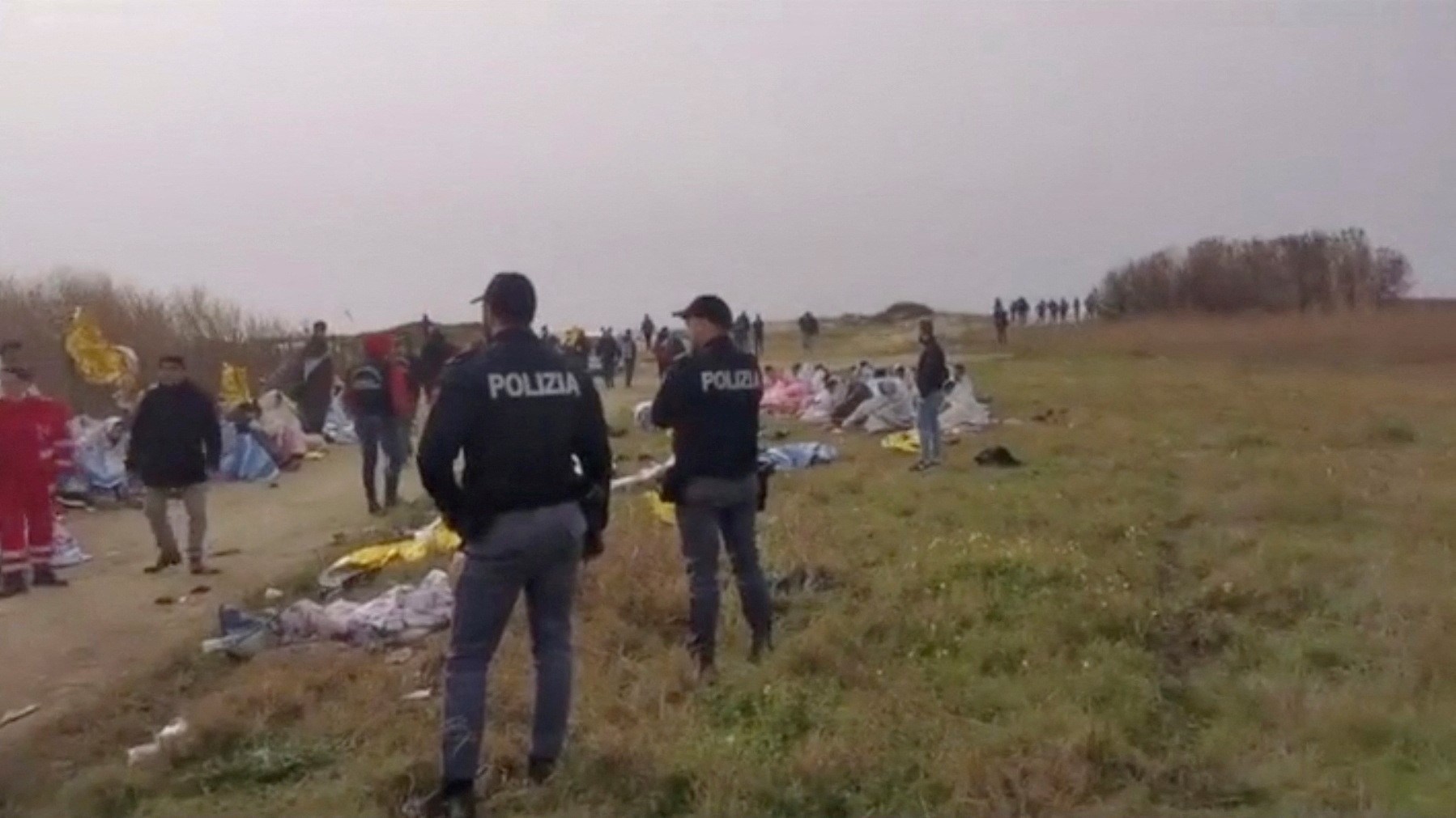 A screengrab taken from a video shows police officers standing at the beach where bodies of believed to be refugees were found after a shipwreck, in Cutro, the eastern coast of Italy's Calabria region, Italy, February 26, 2023. Photo: Reuters