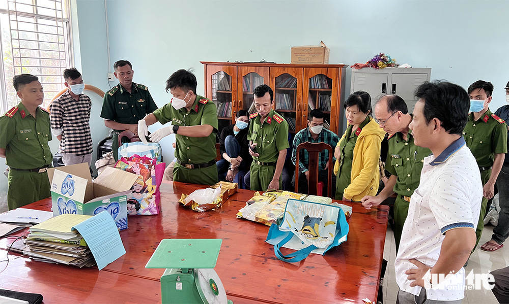 Police officers examine drugs left behind by traffickers in An Giang Province, Vietnam. Photo: Tien Van / Tuoi Tre