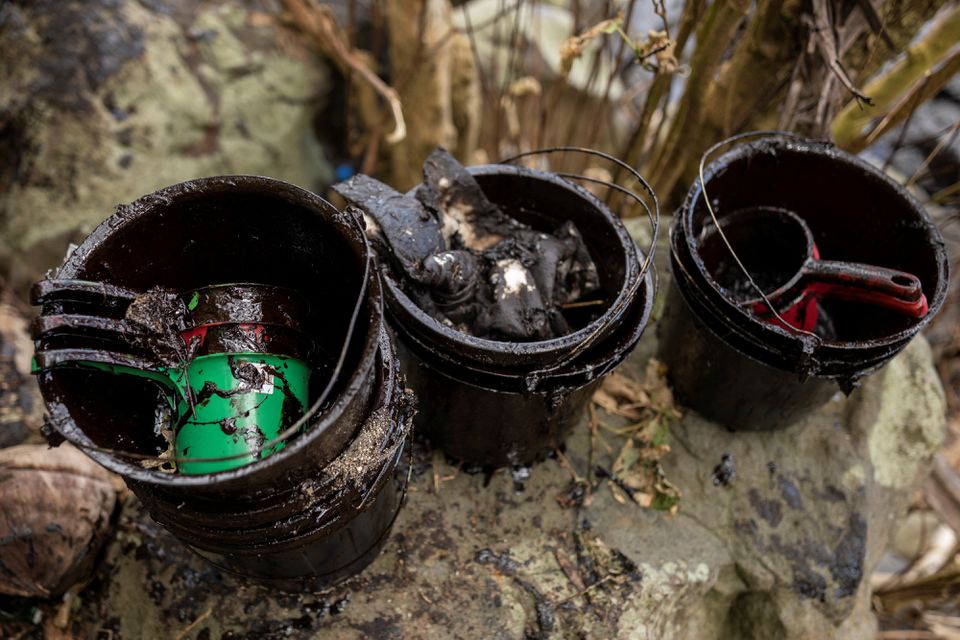 Buckets used to clean up the oil spill from the sunken fuel tanker MT Princess Empress are placed on the shore of Pola, Oriental Mindoro province, Philippines, March 7, 2023. Photo: Reuters