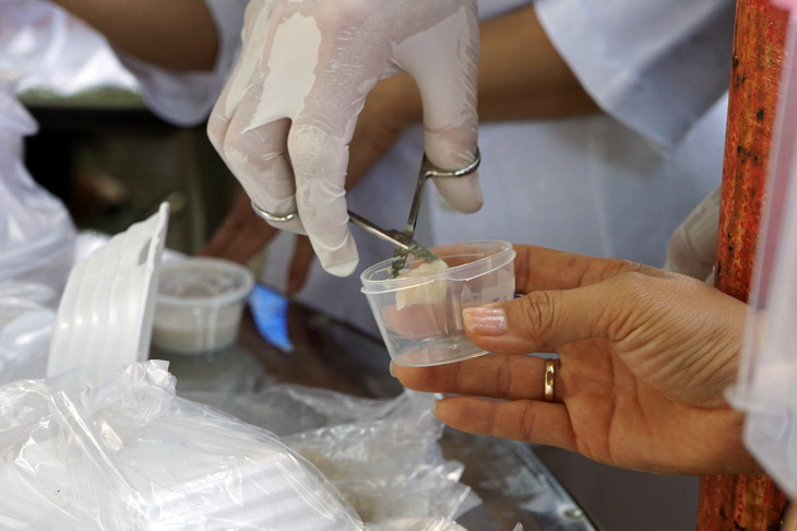 Local authorities sample products at the fair for food safety testing. Photo: A.Loc / Tuoi Tre