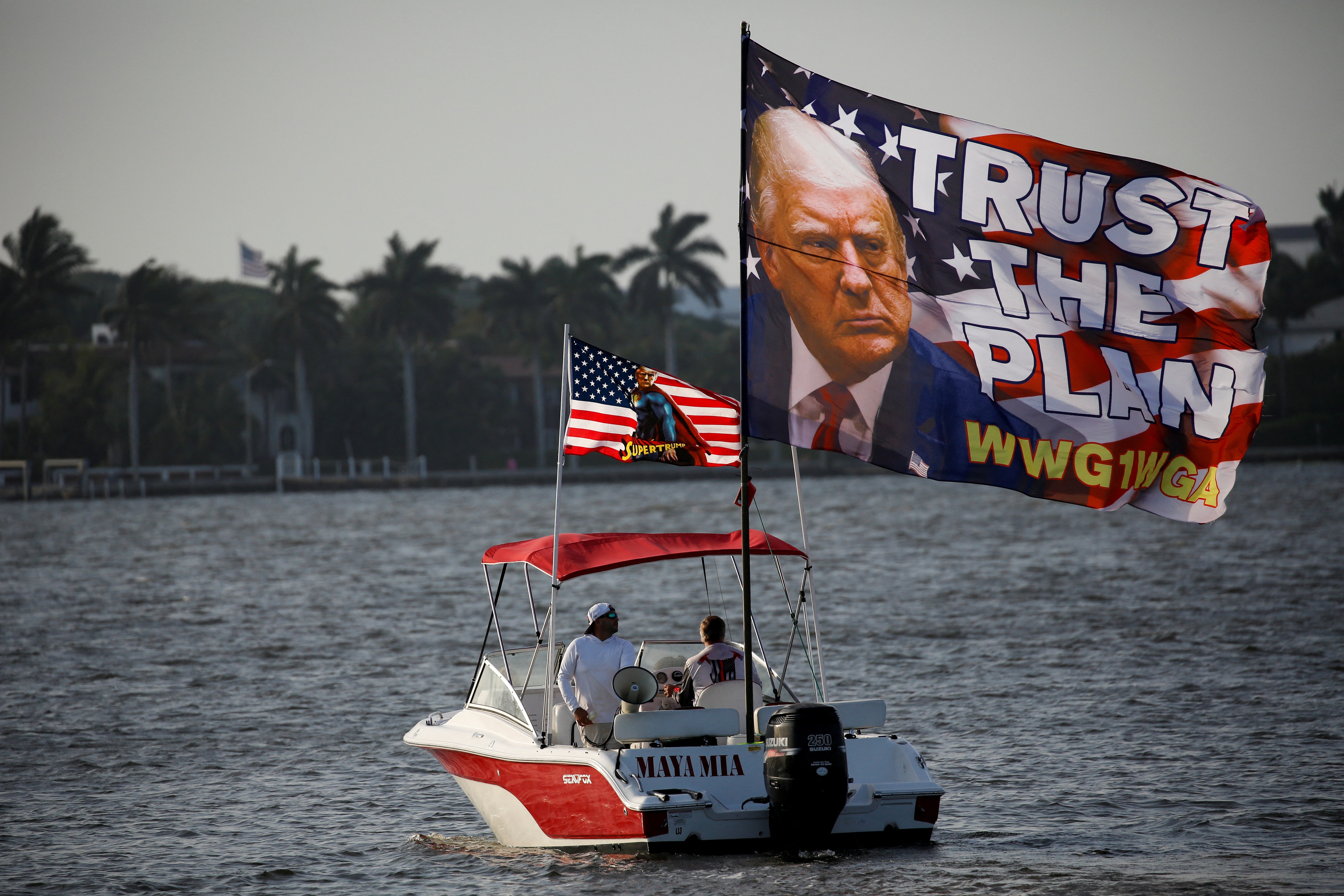 Supporters of former U.S. President Donald Trump are seen on a boat in Lake Worth Lagoon behind his Mar-a-Lago resort after he posted a message on his Truth Social account saying that he expects to be arrested on Tuesday, and called on his supporters to protest, in Palm Beach, Florida, U.S. March 18, 2023. Photo: Reuters