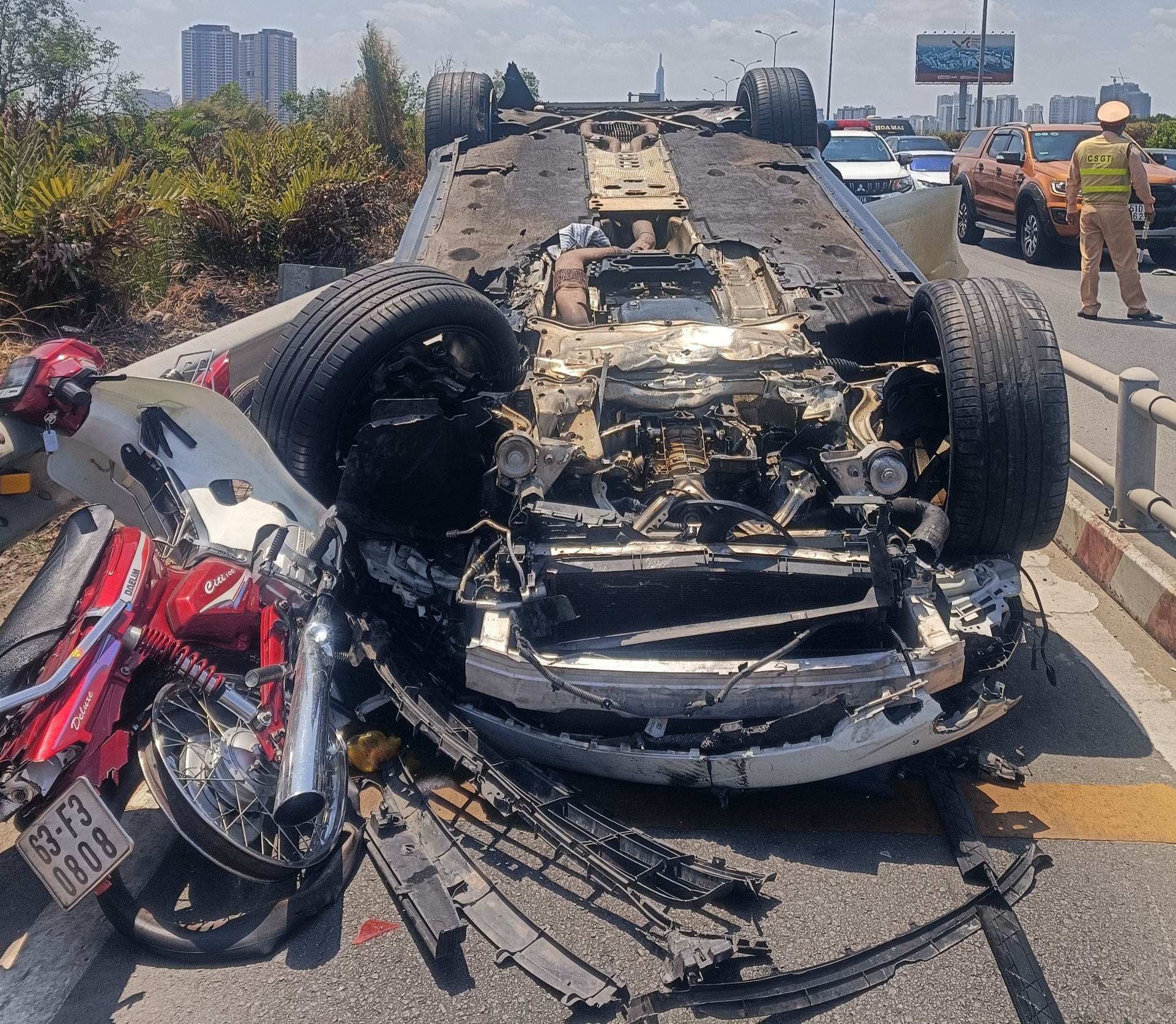 Porsche overturns after sweeping through motorbikes near Ho Chi Minh City expressway