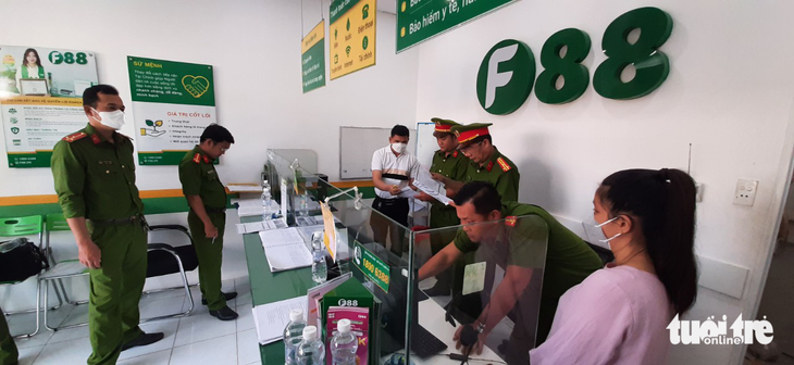 This image shows police officers on an administrative inspection at an F88 branch in My Tho City of Tien Giang Province in southern Vietnam on March 17, 2023. Photo: Quang Lap / Tuoi Tre