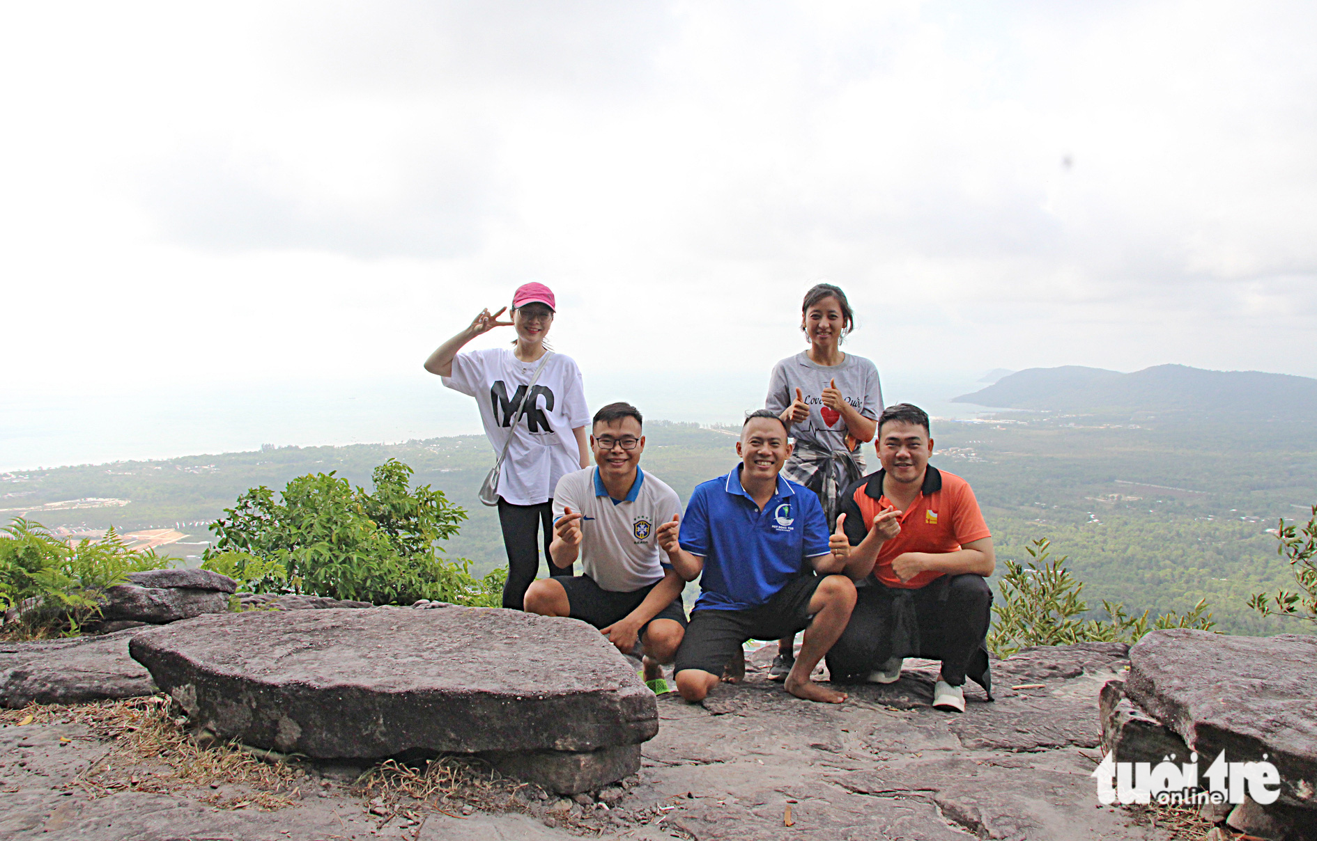 Some members of the cleanup group pose for a photo at the Tien Son mountain peak