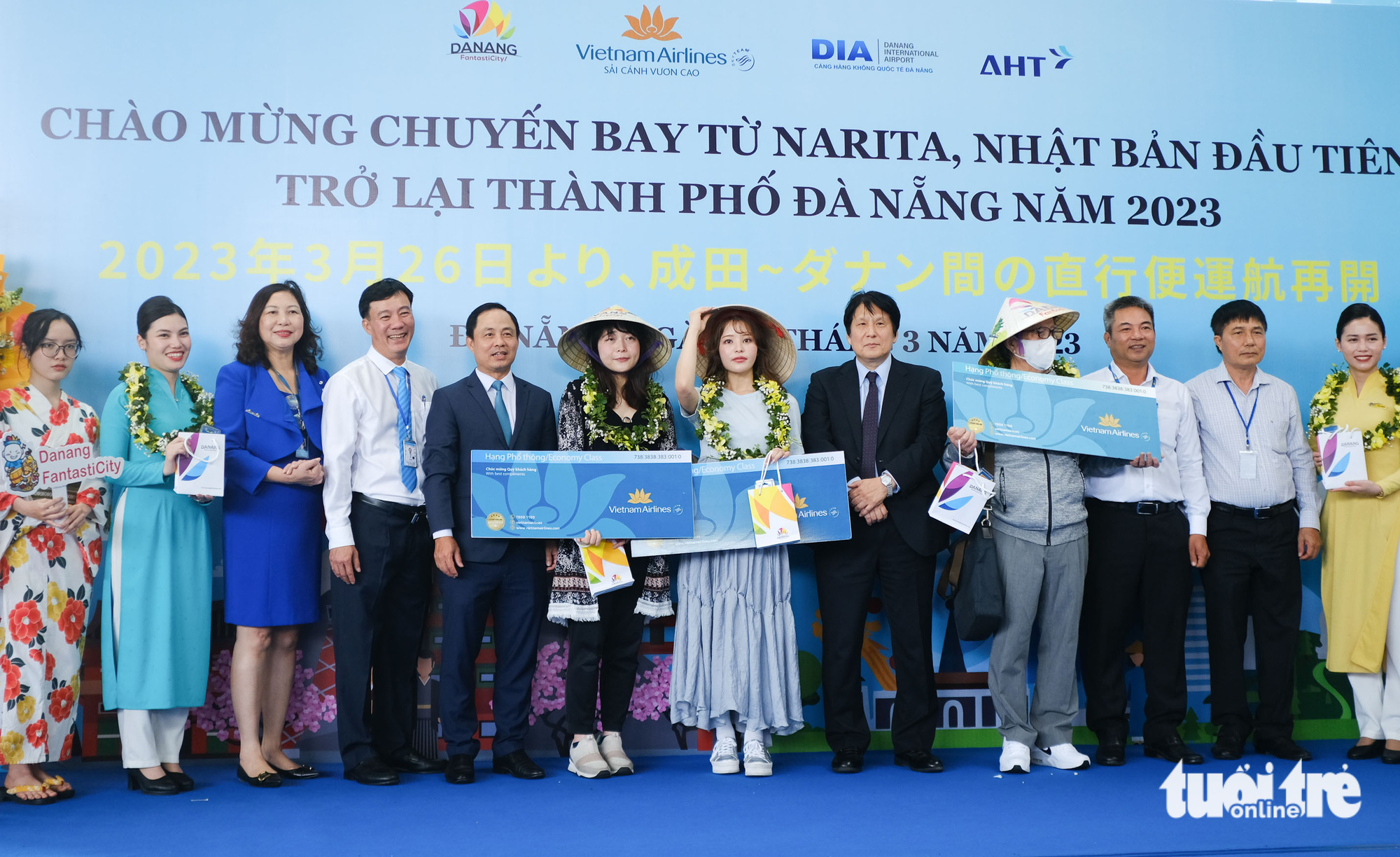 The three luckiest passengers of the flight receive return air tickets from Vietnam Airlines. Photo: Tan Luc / Tuoi Tre